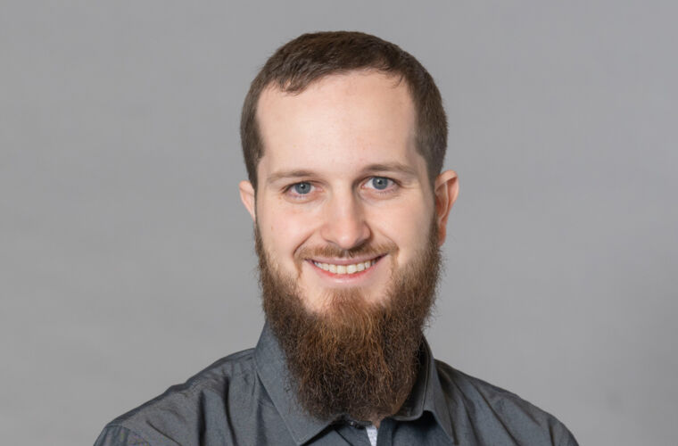 Young man, smiling and looking into the camera.